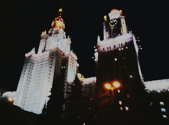 Low angle view of modern building against sky at night