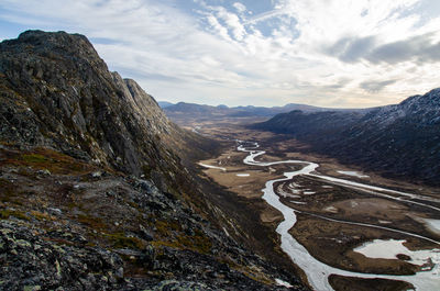 Top down view of a river flowing through leirungsdalen from top of the knutshøe mountain ridge