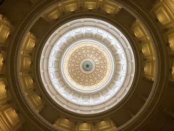 Directly below shot of illuminated ceiling of building