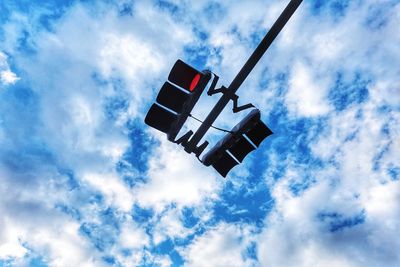 Low angle view of road sign against blue sky