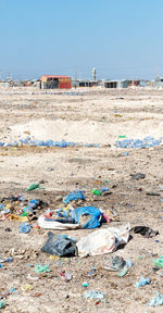 Garbage on beach against clear sky