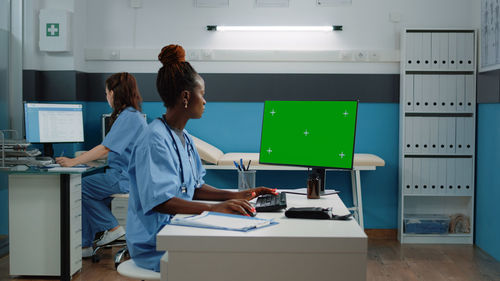 Doctor and nurse using computer at clinic