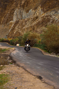 Man riding motorcycle on road