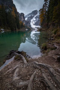 Scenic view of lake by mountains against sky