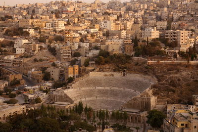 Aerial view of buildings in town during sunset