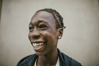 Cheerful teenage boy with braided hair