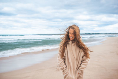 Young woman standing on beach