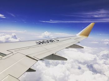 Cropped image of airplane flying over mountain