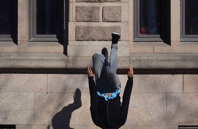 Full length of man jumping outside building