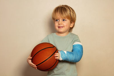 Portrait of boy playing basketball