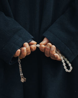 Midsection of woman holding wedding dress