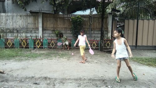 Full length of children on wall