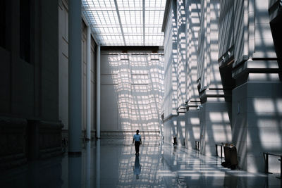 Man walking in corridor of building