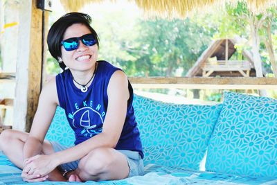 Portrait of smiling young man sitting in swimming pool