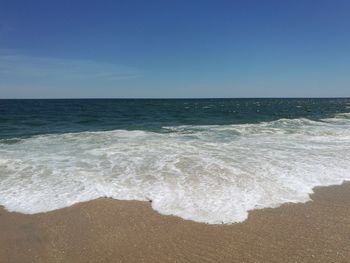 Scenic view of sea against clear blue sky