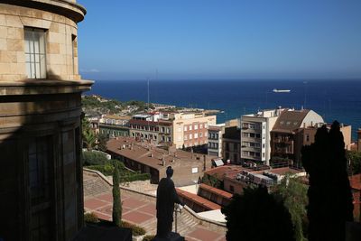 City by sea against clear sky