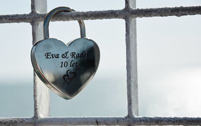 Close-up of love padlocks hanging on metal