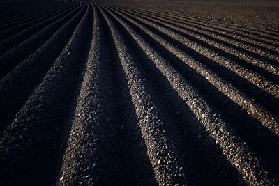 High angle view of tire tracks on field