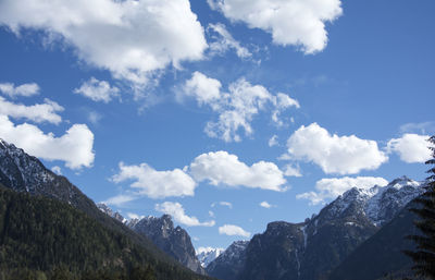 Low angle view of snowcapped mountains against sky