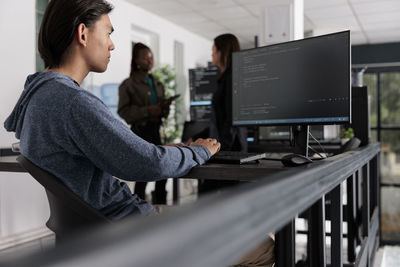 Young businesswoman using laptop at office