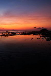 Scenic view of sea against romantic sky at sunset
