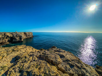 Scenic view of sea against clear blue sky