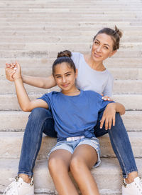 Portrait of a smiling young woman sitting outdoors