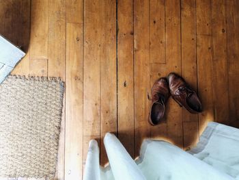 Directly above shot of brown leather shoes on floorboard at home