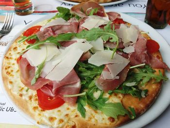 High angle view of pizza served on table