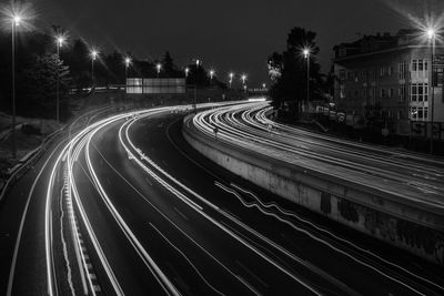 Light trails on road in city at night