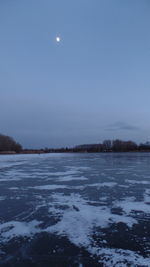 Scenic view of frozen lake against sky at night