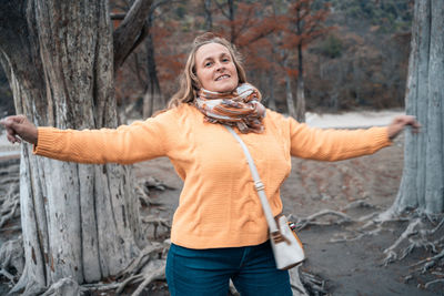 Portrait of a smiling young woman in forest