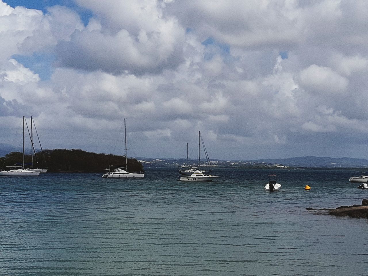 SAILBOAT MOORED ON SEA AGAINST SKY