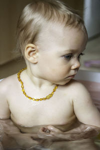 Close-up of cute baby girl in bathtub