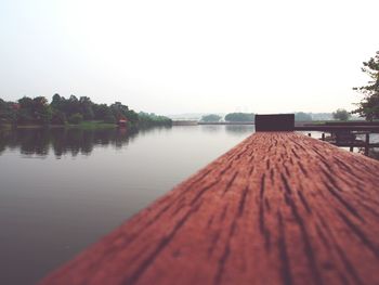 Pier on lake against clear sky