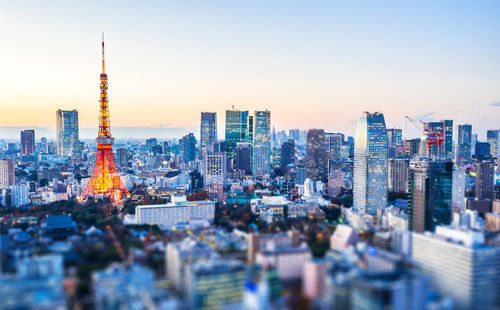 Aerial view of buildings in city during sunset