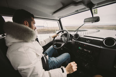 Man sitting in car