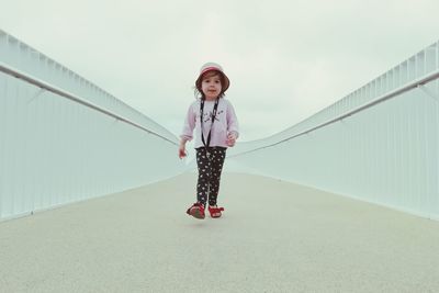 Portrait of girl standing on railing