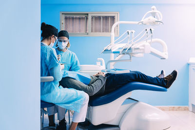 Dentist examining patient in clinic