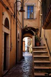 Empty alley amidst buildings in city