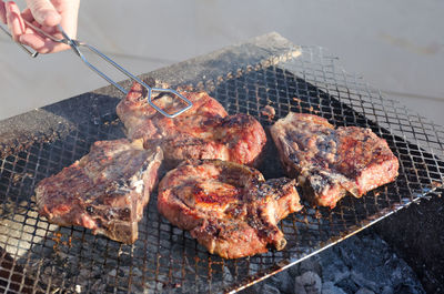 High angle view of meat on barbecue grill