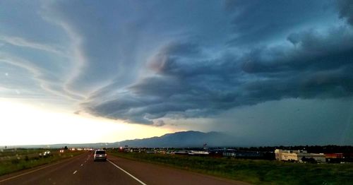 View of highway against cloudy sky