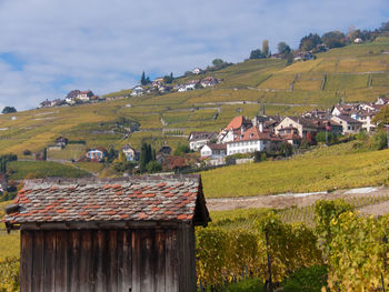 Houses in farm against sky