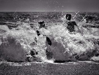 Waves splashing on rocks at beach