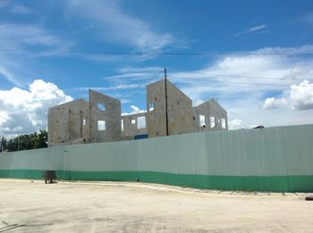 Man in front of built structure against sky