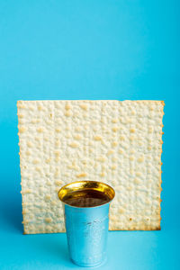 Close-up of drink on table against blue background