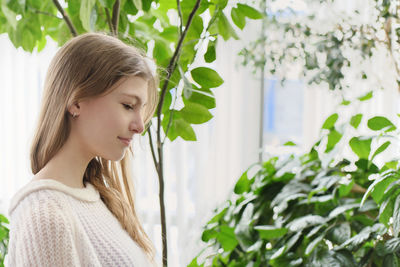 Portrait of a young woman with plants