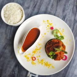 High angle view of india fish curry food in plate on table