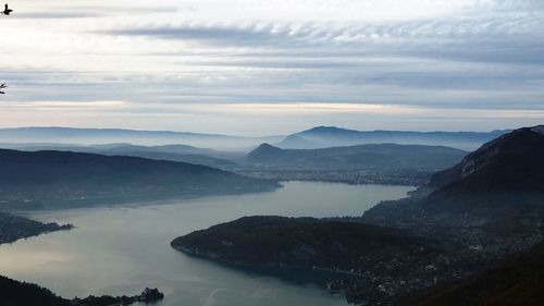 Scenic view of lake and mountains against sky