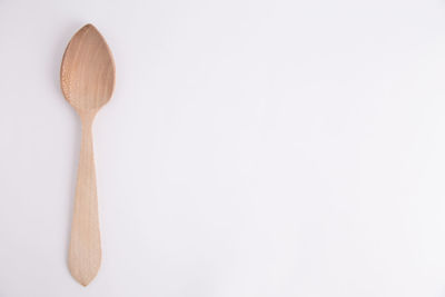 Close-up of wooden spoon against white background
